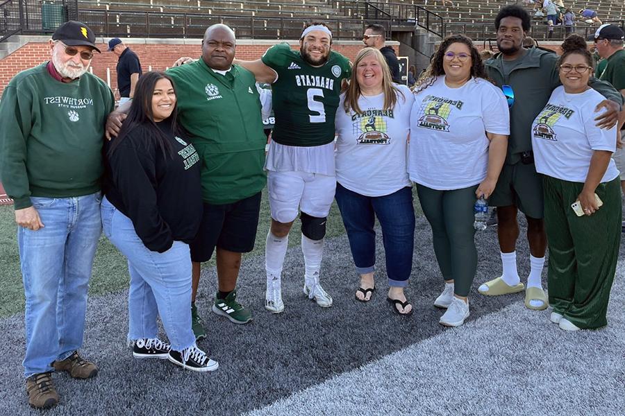 The Green family is pictured after a Northwest football game. Left to right are Kelsi, Adam McNairy, Kaylee, Chelli, Elijah, Clarence and Brooklyn with Dr. Roger Neustadter, a retired Northwest professor and mentor of Dr. Clarence Green. (Submitted photo)